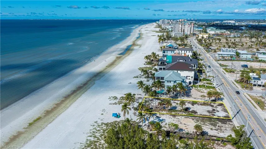 Aerial overview of property's location featuring expansive beach and property boundaries highlighted