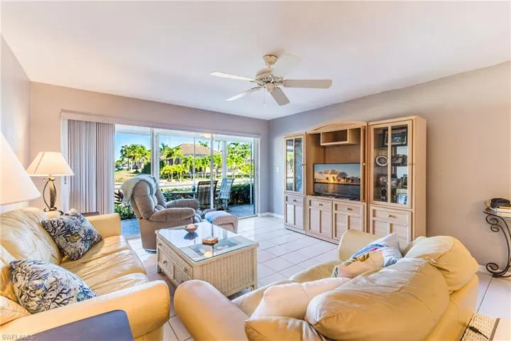 Living area featuring light tile patterned flooring and ceiling fan