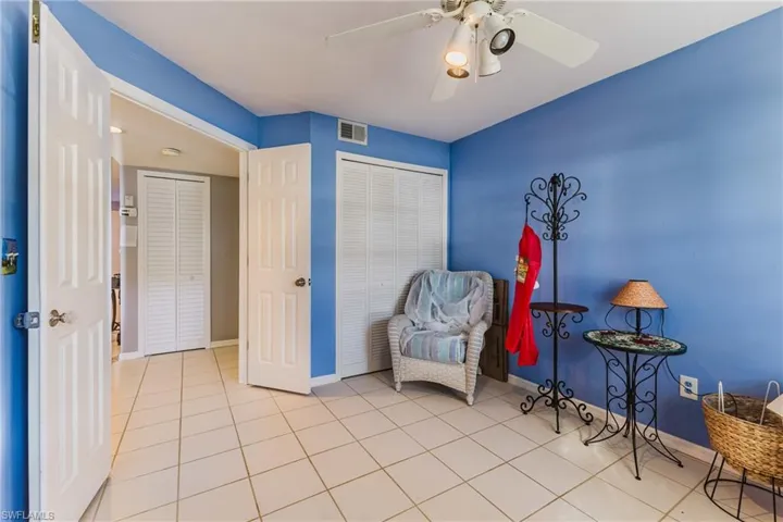 Sitting room featuring light tile patterned floors and ceiling fan