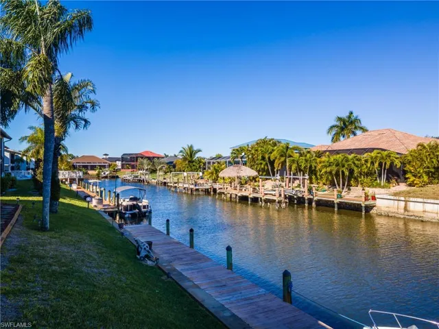 Dock area featuring a water view and a yard