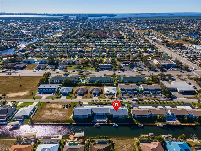 Aerial perspective of suburban area featuring a nearby body of water
