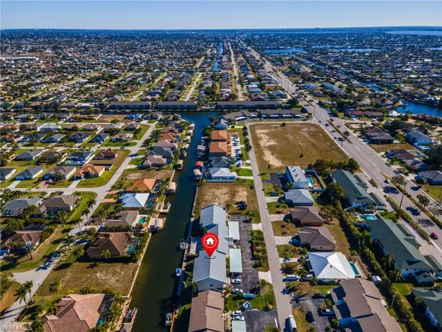 View of property location featuring a large body of water and nearby suburban area