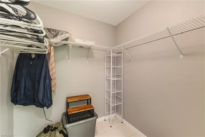 Walk in closet featuring light tile patterned floors
