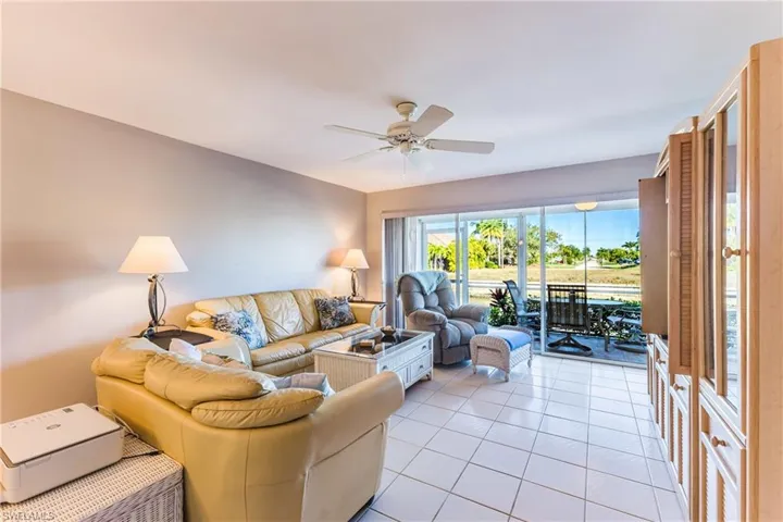 Living area with light tile patterned floors and ceiling fan