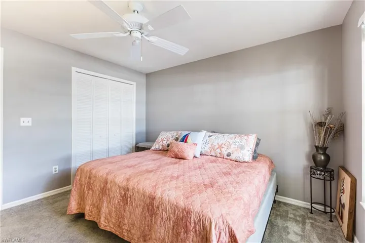 Bedroom featuring carpet, a closet, and a ceiling fan