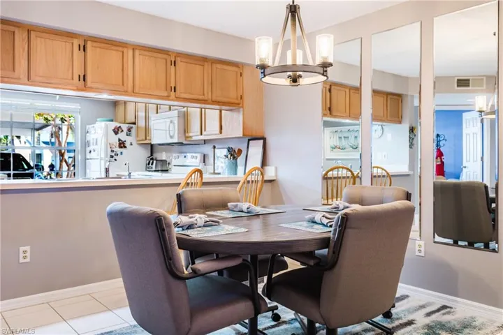 Dining room featuring a chandelier and light tile patterned flooring