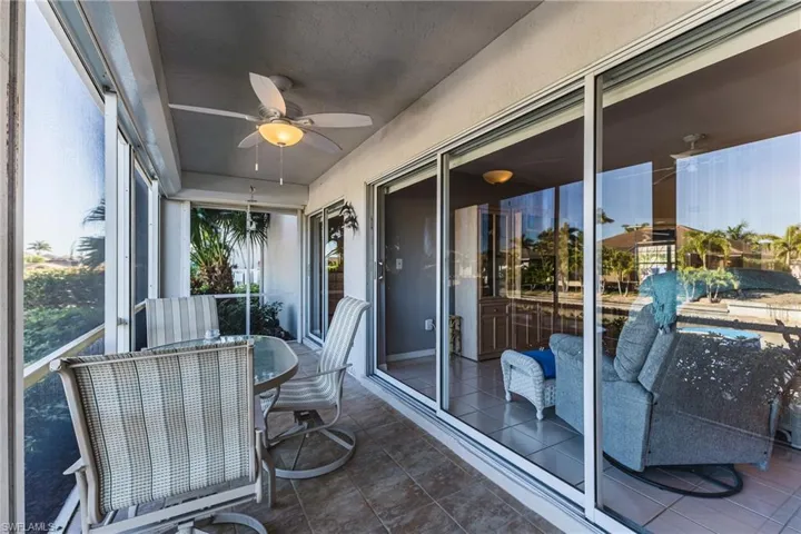 Sunroom with a ceiling fan and outdoor dining space