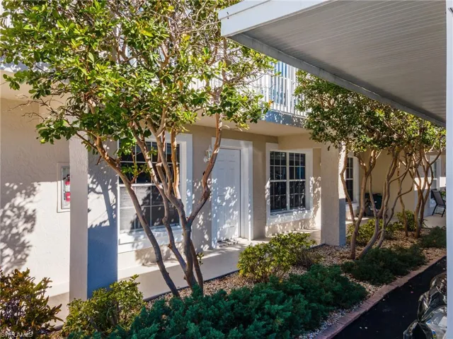 View of side of property with stucco siding and a balcony