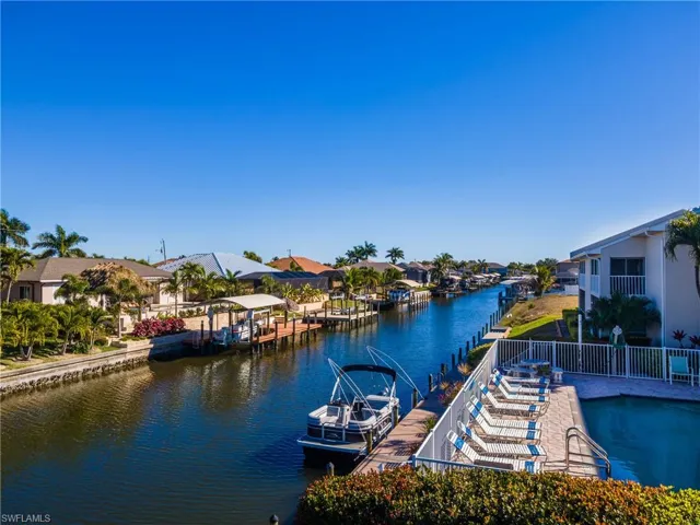 Dock area with a residential view, a water view, and boat lift