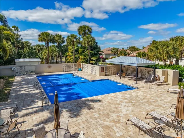 Community pool with a patio