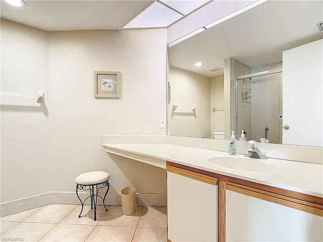 Full bath featuring a shower stall, vanity, recessed lighting, and light tile patterned flooring
