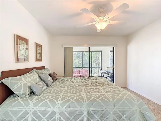 Bedroom with light colored carpet, access to outside, and ceiling fan
