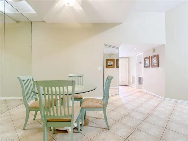 Dining room with light tile patterned floors and baseboards