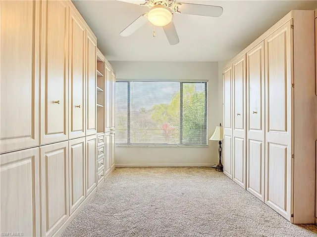 Unfurnished bedroom featuring light carpet and a ceiling fan
