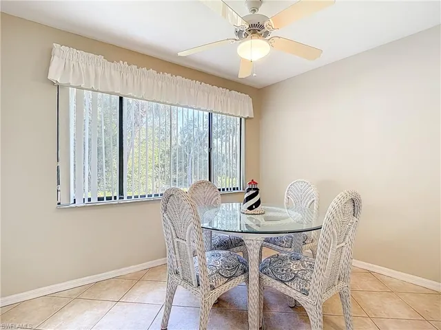 Dining space with baseboards and light tile patterned floors