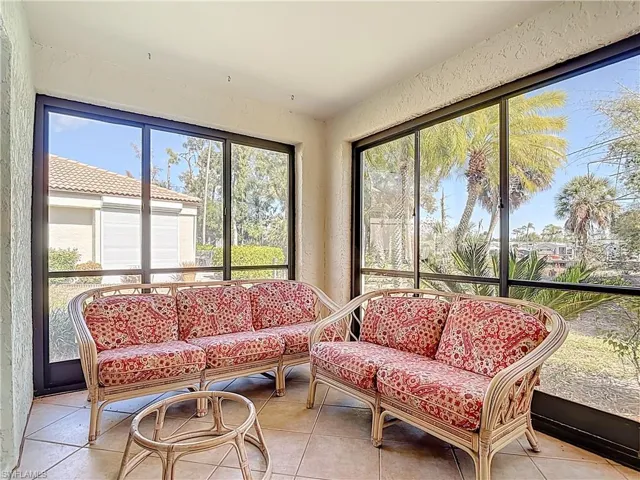 Sunroom with a textured wall and tile patterned flooring