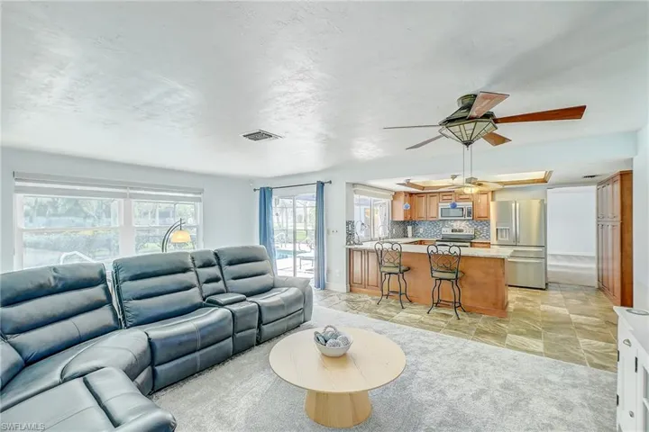 Living room featuring ceiling fan and light tile patterned flooring