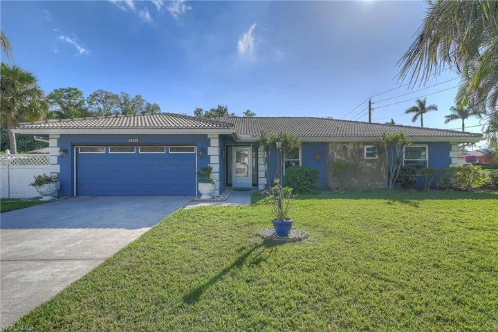 Ranch-style home with a front yard and a garage