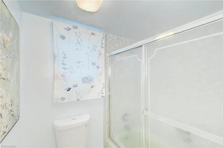 Bathroom with a shower with door and toilet