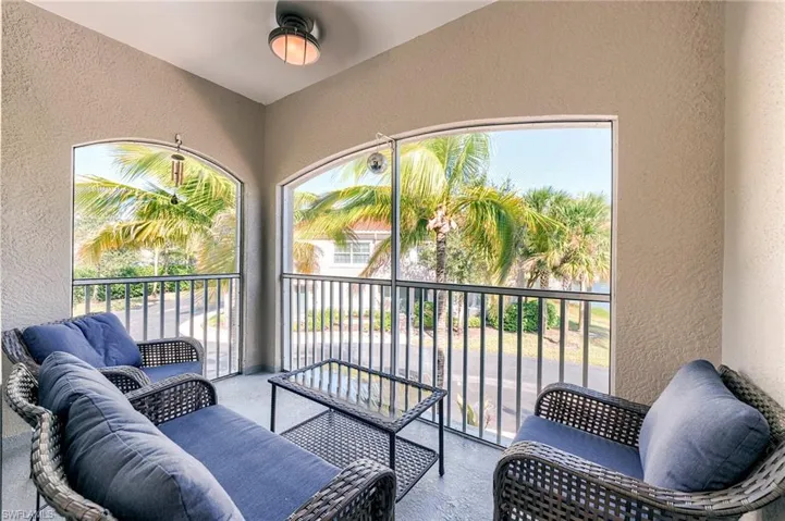 Balcony with a sunroom and an outdoor hangout area