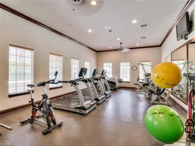 Gym featuring crown molding, recessed lighting, ceiling fan, and a textured ceiling