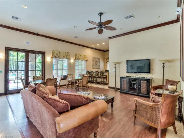 Living area featuring ornamental molding, french doors, a ceiling fan, recessed lighting, and wood finished floors