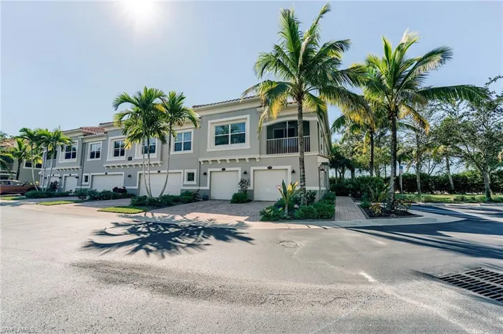 Mediterranean / spanish house with an attached garage, driveway, stucco siding, and a balcony