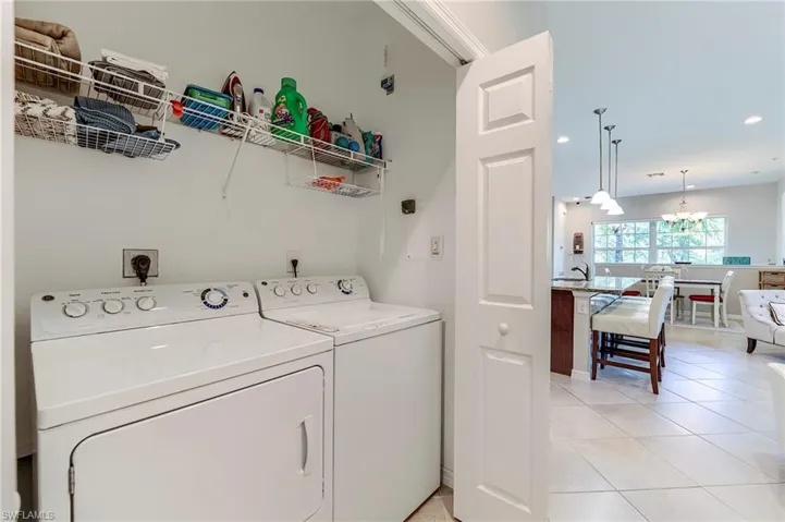 Laundry room with light tile patterned floors, separate washer and dryer, and recessed lighting
