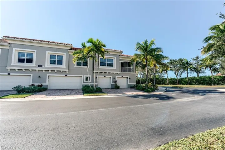 Mediterranean / spanish-style home with stucco siding, a tile roof, driveway, and an attached garage