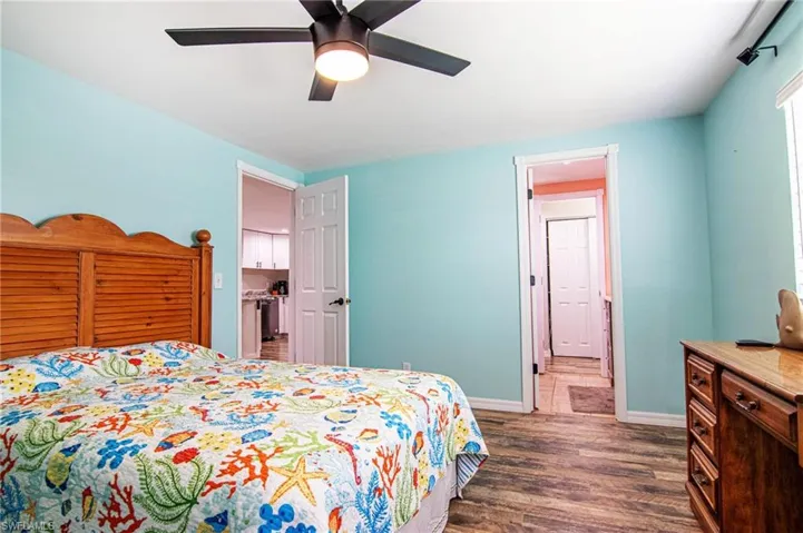 Bedroom with ceiling fan and dark hardwood / wood-style flooring