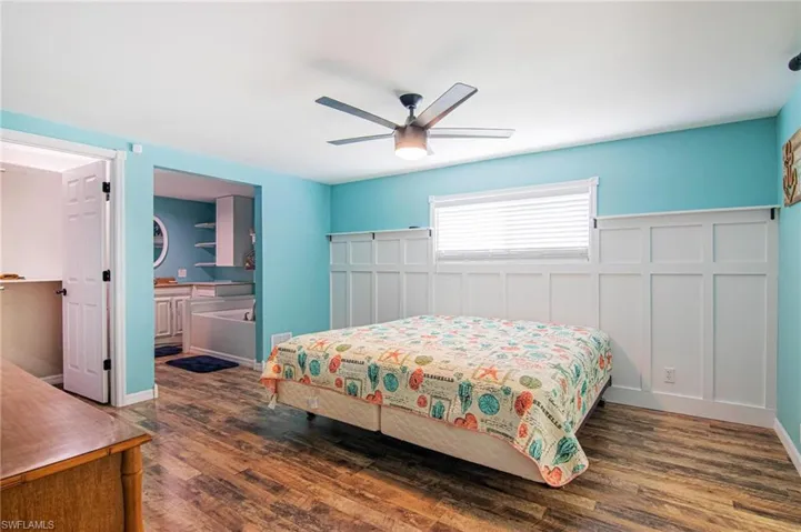 Bedroom with dark wood-type flooring and ceiling fan