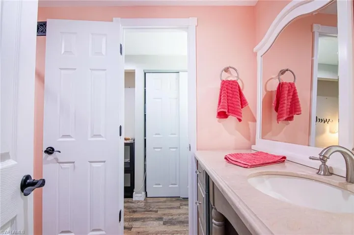 Bathroom with hardwood / wood-style flooring and vanity