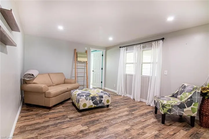 Living room with hardwood / wood-style flooring