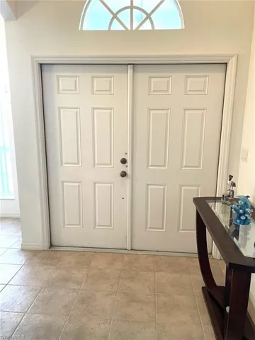 Double door entry with Sunburst window over it