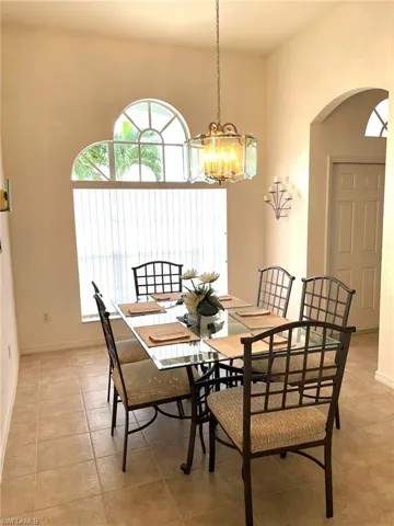 Tiled dining space with a notable chandelier