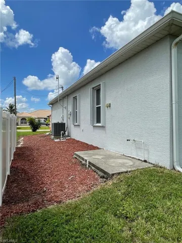 View of home's exterior with cooling unit
