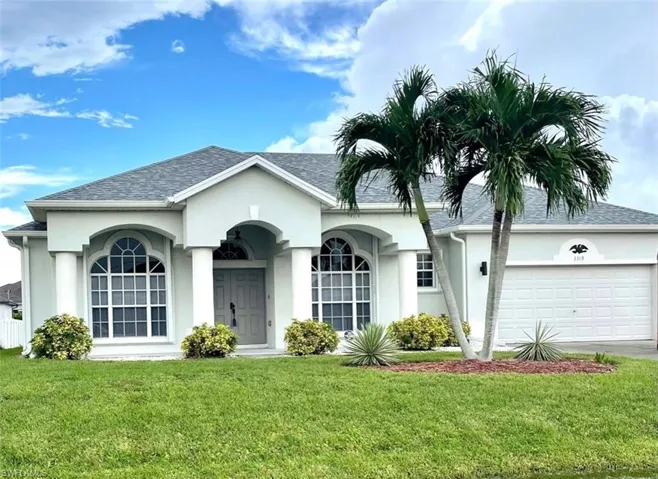 Ranch-style home featuring a garage and a front yard