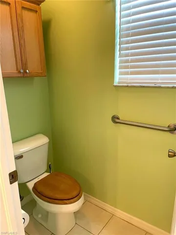 Bathroom One toilet area with cabinetry