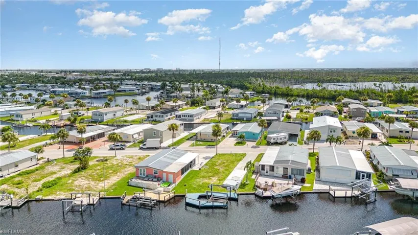 Birds eye view of property with a water view