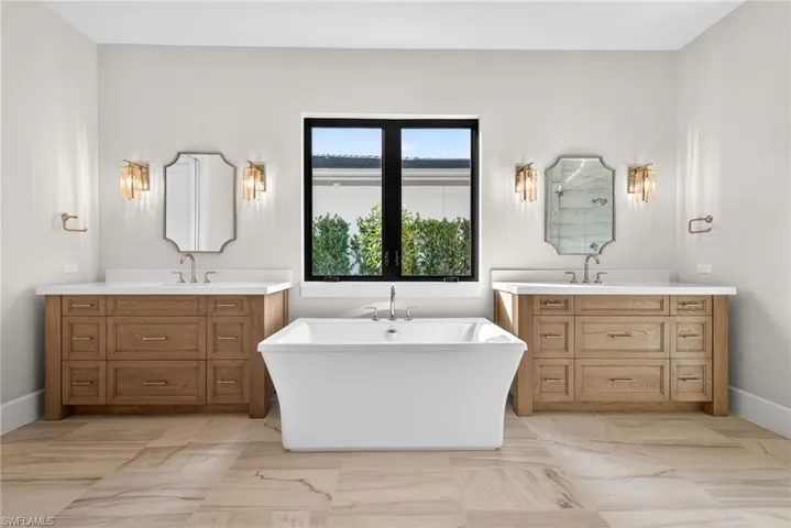 luxurious bathroom with freestanding soaking tub, walk-in shower