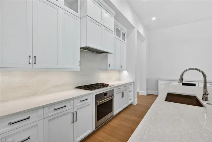 fabulous gourmet-inspired kitchen featuring Sub Zero and Wolf appliances, custom designer wood cabinetry as well as a large island breakfast bar