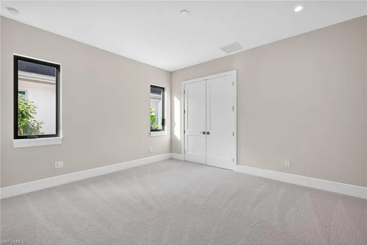 Bedroom 3 featuring light carpeting