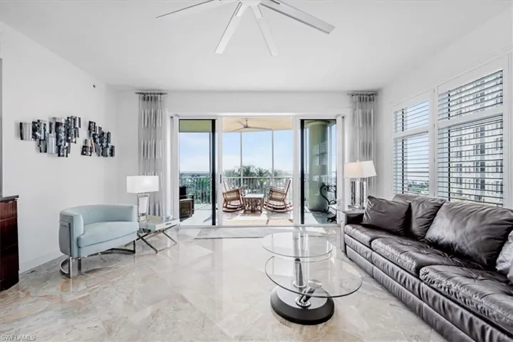 Living area with light marble finish flooring and a ceiling fan