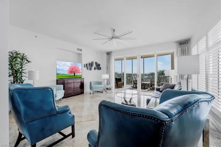 Living area with light marble finish flooring and a ceiling fan