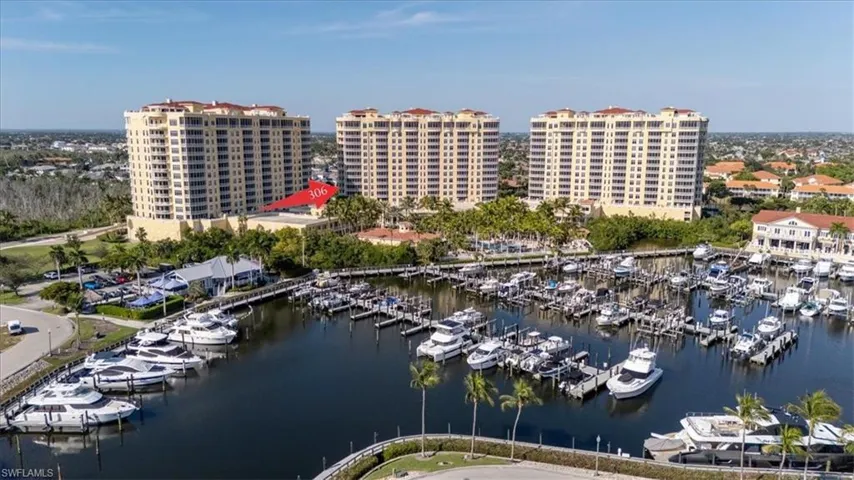 Bird's eye view of numerous boat docks and a nearby body of water