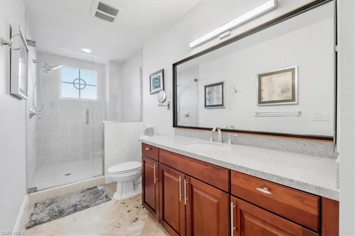 Full bath featuring vanity and a shower stall