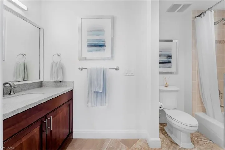 Bathroom with shower / tub combo and vanity