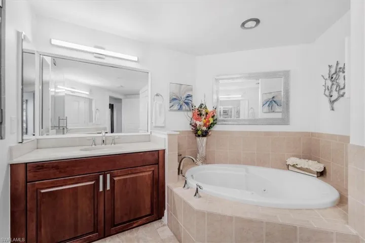 Full bath featuring vanity and a jetted tub