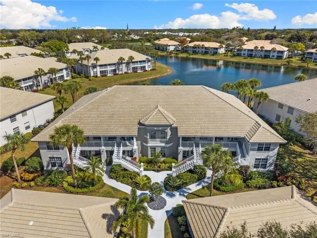 Aerial view of a nearby body of water and apartment complex / building