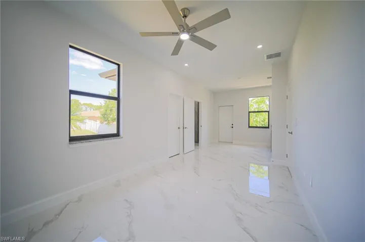 Spare room with light marble finish flooring, recessed lighting, and ceiling fan